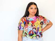 Our AOP tee just went royal! All of your favourite princesses have come together to create a truly must-have piece for your Disney style wardrobe. Featuring the bright and bold colours and styles of each Disney princess, finished with a perfectly pink collar—you’ll need to be adding this allover print tee to your collection ASAP. On this super comfy 100% cotton tee you’ll find: Disney’s Tiana, Moana, Cinderella, Rapunzel, Mulan, Jasmine, Snow White, Pocahontas, Merida, Aurora, Belle and Ariel. - Princesses Disney, Disney Princess Characters, Disney S, Pink Collar, Pink Collars, Disney Shirts, Print Tee, Disney Outfits, Retro Tshirt