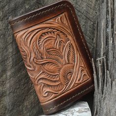 Introducing our exquisitely crafted Handmade Vintage Styled Hand Tooled Leather Wallet! With its elegant minimalist design, this wallet is a must-have. Expertly handcrafted from the finest quality leather, each wallet features unique hand-tooling details that exude a timeless charm. The rich, aged patina gives this wallet a distinctive character, and it only gets better with age. With ample space for all your essentials, this wallet combines functionality with style. Treat yourself or that speci Handmade Classic Wallet, Brown Hand Tooled Trifold Wallet As Gift, Elegant Hand Tooled Leather Wallets, Hand Tooled Brown Wallets As Gift, Rustic Handmade Bifold Wallet, Brown Embossed Wallets For Daily Use, Brown Embossed Wallet For Daily Use, Brown Embossed Wallet, Hand Tooled Bifold Wallet As Gift