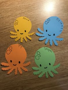 three octopus cut outs sitting on top of a wooden table