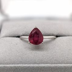 This solitaire ring features a 3.59-carat pear-shaped ruby gemstone with a tapered shank, all set in solid 14K gold. This ring can be a beautiful July birthstone gift for your loved ones! This ring is made with solid 14K Gold. As listed, this ring is ready to ship. If you're interested in purchasing this setting with a different center stone please message us! Designer Silver Jewellery, Jewelry Showcases, Birthstone Gifts, July Birthstone, Ruby Gemstone, Ruby Ring, Earring Findings, Pendant Bracelet, Solitaire Ring