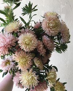 a vase filled with lots of pink and white flowers