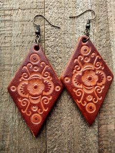 Bohemian Hand-tooled Leather Earrings, Rustic Hand Tooled Leather Jewelry, Brown Hand Tooled Earrings For Festival, Hand-tooled Brown Earrings For Festival, Rustic Hand Tooled Leather Earrings, Brown Leather Stamped Jewelry, Rustic Leather Stamped Jewelry, Brown Bohemian Concho Earrings, Artisan Handcrafted Brown Jewelry