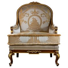 an ornately decorated chair with gold trimmings and white upholstered fabric