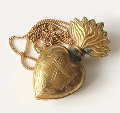 Vintage Sacred Heart Pendant French Gilded Brass Sacred Heart of Jesus Ex Voto Heart of Mary Sacred Flaming Heart Traditional Gold Souvenir Jewelry, Traditional Gold Jewelry Souvenir, Vintage Gold Jewelry Souvenir, Traditional Gold Jewelry For Souvenir, Traditional Gold Jewelry As Souvenir, Antique Keepsake Necklaces With Charms, Gold Medallion Necklace As Souvenir, Gold Medallion Necklace For Souvenir, Vintage Enamel Keepsake Jewelry