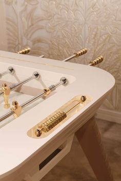 a white table with gold handles on it