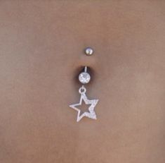 a woman's belly piercing with a star design on it