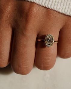 a person's hand with a ring on it