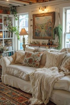 a living room filled with furniture and lots of windows