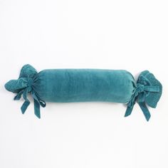 a blue pillow with bows tied around it