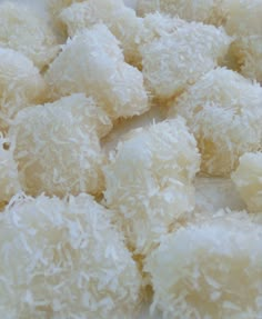 some kind of food that is sitting on a white tablecloth with coconut flakes all over it