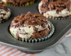 chocolate cupcakes with cream filling in a muffin tin