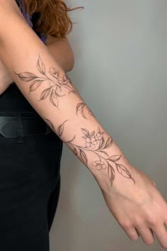 a woman with a flower tattoo on her arm