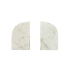 two pieces of white marble are shown on a white background and one piece is cut in half