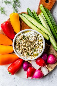 an assortment of vegetables and dip in a bowl