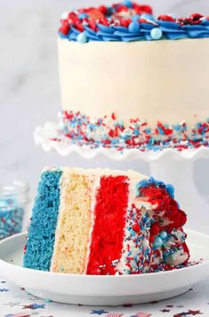 a slice of red, white and blue cake with sprinkles on it