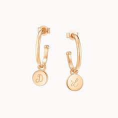 Classic meets contemporary with our personalised disc hoop earrings. Treat yourself or create a personalised gift for someone special by adding a hand-engraved initial of your choice to each charm.18K Champagne Gold Plated or 925 Sterling SilverEarring charm size: Approx. 0.3Hoop size: Mini - 0.5 diameter. Midi - 0.7 diameter. Maxi - 1.4 diameter.Hand-engraved in our Paris workshopSent with love in a complimentary gift boxAny slight variations in lettering depth, spacing and alignment from the examples shown are part of the aesthetic and originality of the piece Personalized Yellow Gold Earrings For Everyday Wear, Elegant Personalized Hoop Earrings For Everyday, Personalized Small Hoop Gold Jewelry, Small Hoop Engraved Earrings, Personalized Small Hoop Earrings As Gift, Personalized Round Hoop Earrings For Everyday, Personalized Everyday Hoop Earrings, Minimalist Round Hoop Earrings With Charms, Minimalist Hoop Earrings With Charms