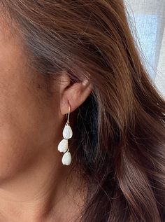 "Pikake triple Gold filled or 925 Silver sparkle dangle earrings Hawaiian Pikake is super popular for the Bride, bridesmaids, mother of the bride, friends or just a beautiful night out on the town. * 2.10\" long * Pierced ear - simple hook earrings * Material: 6 Natural medium White mother of pearl Pikake flowers and 14K Gold Filled Sparkle wire hooks and silicone earring backs to keep them on. Also comes in 925 Sterling Silver. Gold plated Sterling silver sparkle chain This is high quality Natu Sterling Silver Dangle Earrings For Bridesmaids, Dainty Chandelier Earrings For Pierced Ears, Delicate Bridal Earrings In Sterling Silver, Dainty White Chandelier Earrings For Gift, Anniversary Chandelier Earrings With Long Drop, Delicate Earrings For Bridesmaid Gift, Dainty White Chandelier Earrings As Gift, Anniversary Long Drop Chandelier Earrings, Dainty White Linear Earrings