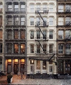 an apartment building in the snow with fire escapes