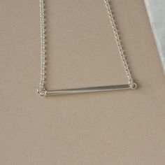 Sterling Silver Bar Necklace - Shiny Horizontal Bar - Modern Layering Necklace This sleek necklace combines a minimalist style with modern elegance and  features a bright and shiny horizontal bar attached to sterling silver rolo chain. The bar measures 35mm wide and it has a thickness of about 2mm so it has some depth to it but it's not overly heavy. The necklace makes a subtle statement and is stylish when worn alone or pair it with other necklaces for an eye-catching layered look. The simple design makes the necklace easy to style and also makes it perfect for everyday wear. The necklace is fastened with a sterling silver spring ring clasp and you can choose your desired length from the drop-down many above. You can find lots more minimalist necklaces here: www.etsy.com/ca/shop/juliegarl Modern Sterling Silver Bar Necklace, Minimalist Sterling Silver Bar Necklace With Rectangular Pendant, Modern Bar Necklace With Adjustable Chain, Modern Bar Necklace With Delicate Chain As Gift, Modern Bar Necklace With Delicate Chain For Gift, Modern Everyday Bar Necklace With Adjustable Chain, Minimalist Silver Bar Necklace As Gift, Silver Bar Necklace With Delicate Chain For Everyday, Simple Bar Necklace With Delicate Chain