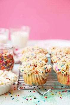 cupcakes with sprinkles on a cooling rack