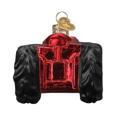 a red and black monster truck ornament hanging from a hook on a white background