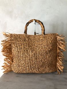 Bohemian Straw Bag With Bamboo Handle For Shopping, Bohemian Straw Bag For Beach Season Shopping, Chic Palm Leaf Tote Bag, Bohemian Natural Beach Bag For Shopping, Natural Bohemian Beach Bag For Shopping, Chic Brown Palm Leaf Bag, Beige Palm Leaf Shopping Bag, Chic Brown Palm Leaf Bags, Jute Beach Tote With Bamboo Handle