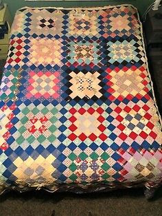 an old quilt is laying on the floor