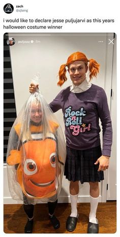 two girls standing next to each other in front of a mirror with an orange fish costume on