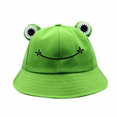 a green hat with eyes and ears on the front, sitting in front of a white background