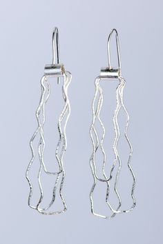 Silver Earrings - A playful addition to any jewelry collection, these sterling silver drop earrings have a delicately hammered texture that reflects the light as they move. Sterling silver French hooks. Contemporary Silver Drop Earrings, Contemporary Teardrop Sterling Silver Earrings, Fusion Sterling Silver Earrings With Ear Wire, Silver Hammered Sterling Silver Linear Earrings, Modern Sterling Silver Drop Linear Earrings, Modern Sterling Silver Linear Earrings With Hammered Detail, Modern Hammered Sterling Silver Earrings, Modern Hammered Sterling Silver Linear Earrings, Modern Sterling Silver Hammered Earrings