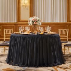 the table is set with wine glasses and plates