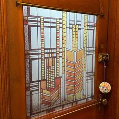 a bathroom door with a stained glass window