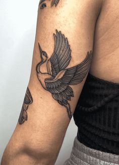 a man with a bird tattoo on his arm