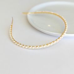 Add a touch of elegance to your wedding hairstyle with our dainty pearl headband. This exquisite bridal hair accessory is perfect for any bride seeking a chic and sophisticated look on her special day.  DETAILS: - Each item is made to order and delicately handcrafted - 3mm wide metal headband (gold or silver) - One size fits most - Wrapped with silver or gold plated jewelry wire - High quality glass pearls (white or ivory) - Easy to wear and will complement any bridal hairstyle - Excellent styli Bride Short Hair, White Pearl Headband, Short Hair Accessories, Short Hair Bride, Pearl Bridal Headband, Simple Headbands, Minimalist Bride, Bride Headband, Metal Headband