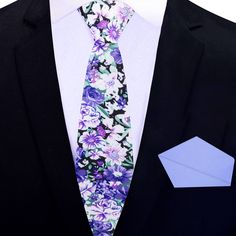 Purple, Green, and White Floret Silk Tie Picture this: you're dressing up for a special occasion, and you want to make a bold statement with your outfit. You reach for a luxurious silk necktie that catches your eye. Its luscious fabric feels silky smooth in your hands, and the intricate floral pattern in shades of purple, green, and white is mesmerizing. The playful yet sophisticated design makes you feel confident and daring. As you tie the knot of the necktie, you realize that the soft purple Elegant Floral Print Accessories For Black Tie, Summer Formal Ties With Floral Print, Elegant Patterned Tie With Floral Print, Elegant White Ties For Spring, White Suit And Tie Accessories For Business In Spring, Elegant White Spring Ties, Multicolor Floral Print Wedding Ties, Formal White Suit And Tie Accessories With Floral Print, White Floral Print Tie For Formal Occasions