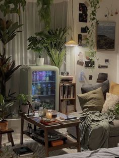 a living room filled with furniture and lots of plants