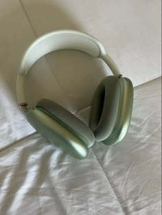 a pair of headphones sitting on top of a bed