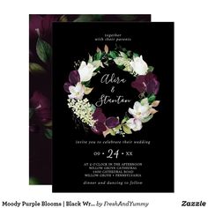 a wedding card with purple flowers and greenery in the middle, on black background