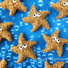 star shaped cookies with googly eyes are on a blue surface