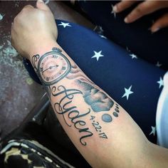 a person with a tattoo on their arm has a clock and the words happy new year