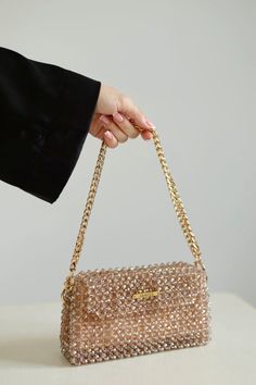 Crystal beaded bags are popular choices for formal occasions, evening events, or any time when a touch of glamour is desired. They can add a statement-making element to an outfit and are often chosen to complement elegant dresses or evening gowns. The beaded texture of the bag not only adds visual interest but also provides a tactile and luxurious feel. Whether you're treating yourself or searching for the perfect gift for a fashion-forward friend, this crystal beaded bag is sure to impress. Elevate your style with this eye-catching accessory and turn heads wherever you go. Luxury Evening Shoulder Bag For Mobile Phone, Square Shoulder Bag For Party, Elegant Shoulder Bag With Chain Strap As Gift, Beige Crossbody Box Bag For Evening, Trendy Rectangular Shoulder Bag For Parties, Trendy Mobile Phone Shoulder Bag For Parties, Trendy Shoulder Box Bag For Party, Trendy Rectangular Bag For Parties, Luxury Party Crossbody Box Bag