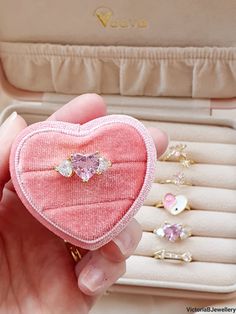 A 18k gold plated chunky pink heart ring with cubic zirconia's which is great for every season and every occasion. This cute bold heart ring features a big pink heart cubic zirconia centre stage with two large silver cubic zirconia stones either side. Great for stacking with other statement rings to give of a more dramatic and bold Instagram worthy look. Nice and light weight so it will not feel a burden to wear all day long. ♡ All rings will come with a small pink velvet pouch to store in to keep them from being scratched and tarnished and last longer ♡ MATERIALS: - Band: Brass - 18k gold plated - Stones: Cubic Zirconia SIZE: Initial size is 6 (16.9mm) but is slightly adjustable and can be stretched open carefully HOW TO CARE FOR YOUR JEWELLERY To keep jewellery looking fresh and extend i Pink Heart-shaped Gemstone Jewelry, Pink Heart-shaped Cubic Zirconia Rings, Pink Heart Ring In Cubic Zirconia, Fine Jewelry Style, Pink Fine Jewelry Rings For Valentine's Day, Gold Heart-shaped Crystal Ring For Gift, Pink Heart Ring With Vs Clarity As Gift, Gift Heart Ring With Cubic Zirconia And Open Design, Pink Cubic Zirconia Heart Ring Fine Jewelry, Valentine's Day Pink Gold Heart Cut Ring