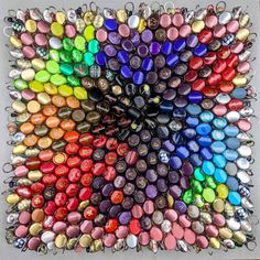 a multicolored art work made out of buttons