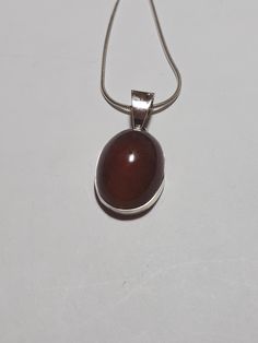 Baltic amber pendant.  From the Baltic sea.  Polish residents find amber on the shores of the sea after a storm, and gather it up, and cut and polish it into gemstones for jewelry and other uses. I have set this in the new highly tarnish resistant silver known as Argentium silver.  It is whiter and shines up brighter than regular sterling silver. I gift wrap all purchases.   I ship by USPS priority mail.  I ship in the US and Canada. Thank you for shopping at garysjewelry on Etsy. Brown Oval Gemstone Jewelry, Brown Sterling Silver Round Pendant Necklace, Sterling Silver Brown Round Pendant Necklace, Brown Pendant Jewelry With Natural Inclusions, Baltic Amber Cabochon Necklace For Gift, Cabochon Baltic Amber Necklace As Gift, Brown Oval Spiritual Jewelry, Spiritual Brown Oval Jewelry, Elegant Brown Necklace With Polished Finish