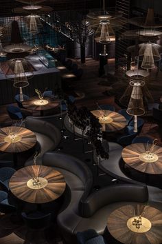 an overhead view of tables and lamps in a room with wooden floors, black walls and flooring