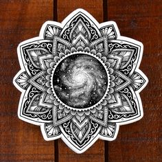 a black and white sticker with an intricate design on the center, surrounded by stars