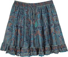 A slightly shiny and smooth short skirt with three tiers of lightweight smooth fabric. This peacock blue skirt has paisley and floral print all over the fabric with a blue slightly frilled bottom. #tlb #TieredSkirt #Floral #Printed #Paisley #Fairycoredress #VacationShortSkirt #BeachSkirt Short Hippie Skirt, Blue Tiered Lined Skirt, Blue Lined Tiered Skirt, Blue Tiered Skirt With Lining, Blue Bohemian Tiered Bottoms, Flowy Paisley Print Tiered Skirt, Bohemian Blue Tiered Bottoms, Flowy Tiered Skirt With Paisley Print, Bohemian Blue Mini Skirt