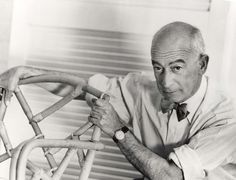 an old black and white photo of a man working on a piece of furniture with canes