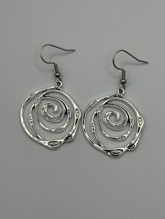 Silver Swirl Geometric Earrings,  Swirls Dangle Drop Earrings, Swirly Jewelry, Spiral Earrings,Trendy Earrings, Geometric Spiral,Gift for Her, Birthday Gift, appreciation gift, Just because Gift, Gift for her, Mother's Day gift.  Free shipping in the USA I do not ship invoices unless requested. Feel free to message me if you have any questions. I would be happy to help. Other Spiral Jewelry: https://www.etsy.com/listing/1268065642/gold-swirls-dangle-drop-earrings-swirly?click_key=9bc01de610b1d996c38d2a51442d7993b71d3658%3A1268065642&click_sum=074bc59b&ref=shop_home_active_102&frs=1&crt=1 Swirl Earrings Spirals, Swirl Shaped Nickel-free Hoop Earrings As Gift, Nickel-free Swirl Hoop Earrings Gift, Swirl Hoop Earrings Nickel Free Gift, Swirl Shaped Metal Earrings As Gift, Swirl Shaped Metal Earrings For Gift, Swirl-shaped Earrings With Ear Wire, Silver Swirl Earrings, Hypoallergenic Spiral Metal Earrings