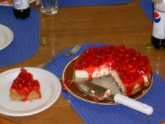 a piece of cheesecake with cherries is on a plate